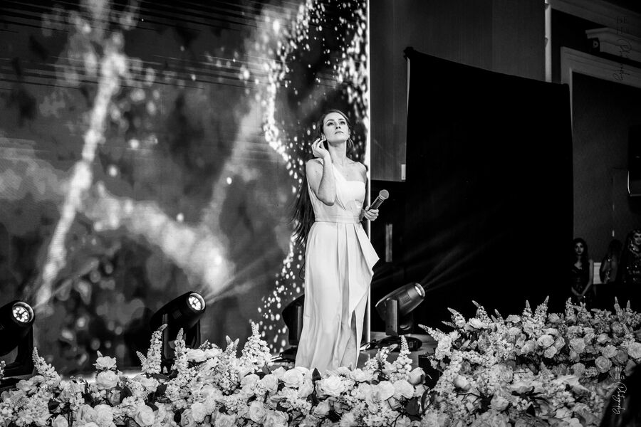 Regina Bianca performing on stage in dramatic light